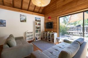 a living room with a couch and a tv at Huttopia Vallouise in Vallouise