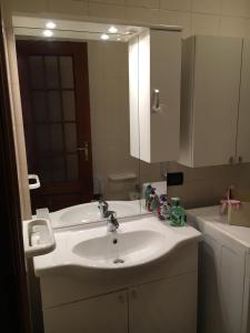 a bathroom with a white sink and a mirror at Casa Camilla CIR 0058 in Aosta