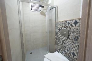 a shower with a glass door in a bathroom at Beach Suites İçmeler Marmaris in İçmeler