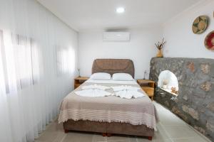 a bedroom with a bed with towels on it at Beach Suites İçmeler Marmaris in İçmeler
