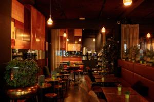 a restaurant with tables and chairs and a bar at HotelO Kathedral in Antwerp
