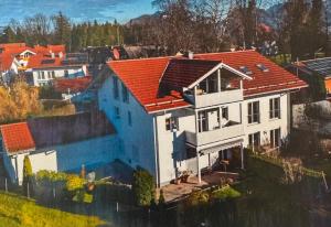 an aerial view of a house with an orange roof at Das Alpenhostel in Brannenburg