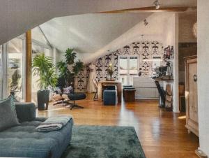 a living room with a couch and a table at Das Alpenhostel in Brannenburg +10 photos