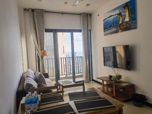 a living room with a couch and a large window at Colombo Trizen J&J future Apart ment in Colombo