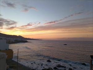a view of the ocean at sunset at Casa Atardecer in Moya