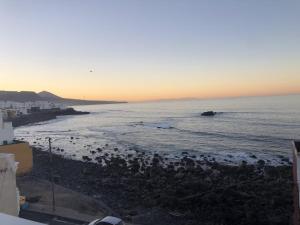 a group of birds on the beach at sunset at Casa Atardecer in Moya +2 photos