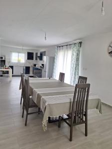 a dining room with a table and chairs and a kitchen at Villa Goyavier in La Plaine des Palmistes