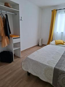 a bedroom with a bed and a desk and a window at Villa Goyavier in La Plaine des Palmistes