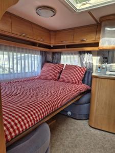 a bed in the back of an rv at La Bordu in Grandson