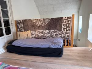 a bed with a headboard in a room at Højmosegård ÅBENT HEMS in Varde