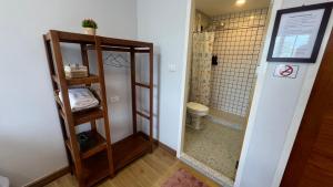 a bathroom with a toilet and a walk in shower at บ้านตลาด สัตหีบ in Sattahip