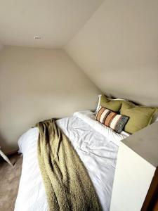 a bedroom with a bed in a attic at Modern Cotswolds Studio in Bishops Cleeve