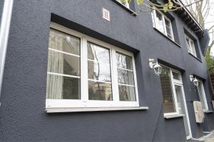 a black house with white windows on the side of it at Petit Wannsee GmbH in Berlin