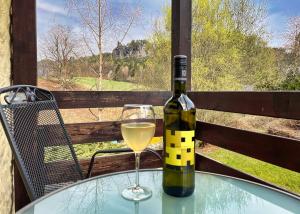 a bottle of wine sitting on a table with a glass at Pension Zum Talwächter im Sandsteinidyll in Rathen +29 photos