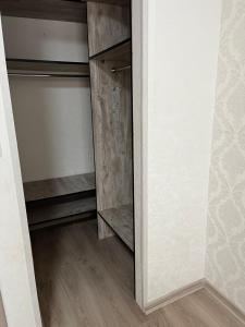 a room with a closet with wooden shelves at Затишна трьохкімнатна квартира у Львові in Lviv