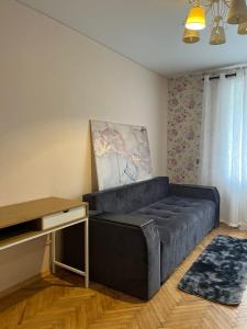 a living room with a large couch in a room at Затишна трьохкімнатна квартира у Львові in Lviv