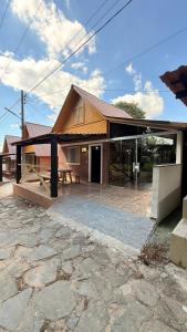 a house with a pavilion in front of it at Pousada e Camping Carrion in Itu