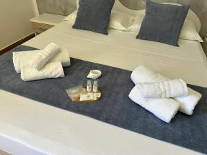 a bed with two pillows and towels on it at Il vecchio e il mare in San Vito lo Capo +50 photos