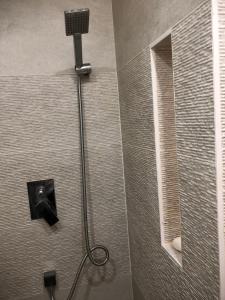 a shower with a shower head in a bathroom at Un petit nid au calme, à 4 minutes de la plage ! in Banyuls-sur-Mer