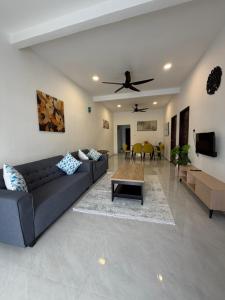 a living room with a couch and a table at D' Ehsan Homestay & Chalet in Kuala Terengganu