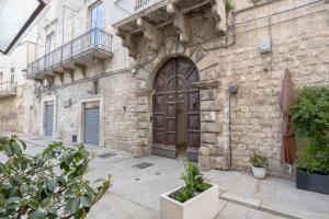 an old stone building with a wooden door at Andromeda in Modugno