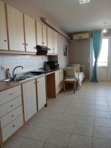 a kitchen with white cabinets and a tile floor at Blue Hour in Monemvasia +19 photos
