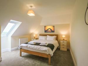 a bedroom with a bed with two night stands and a window at 1 Dawson Court - Uk33410 in Mablethorpe