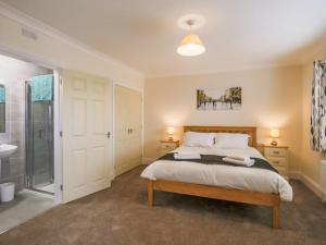 a bedroom with a large bed and a shower at 1 Dawson Court - Uk33410 in Mablethorpe