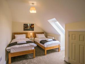 a bedroom with two beds in a attic at 1 Dawson Court - Uk33410 in Mablethorpe +2 photos