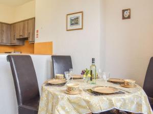 a table with plates and glasses and a bottle of wine at Whitby Apartment in Commondale