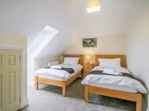 two twin beds in a room with a staircase at 4 Dawson Court - Uk33414 in Mablethorpe +2 photos