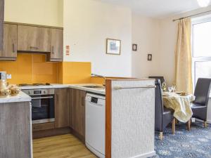 a kitchen with a table and a dining room at Whitby Apartment in Commondale