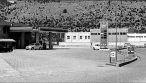 a gas station with cars parked at a gas station at Kokaj3B in Hani Hotit