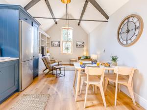 a kitchen and dining room with a table and chairs at The Old Workshop - Cottage in Broom