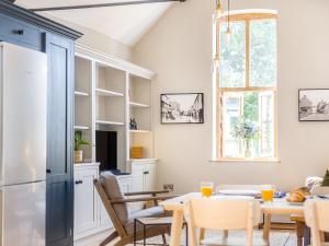 a kitchen and dining room with a table and chairs at The Old Workshop - Cottage in Broom