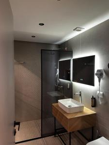 a bathroom with a sink and a shower at Hotel Liss in Lezhë +43 photos