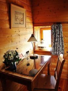 a wooden room with a wooden table and a lamp at Chambre Fleur bleue, les Volets Bleus in Laneuvelotte