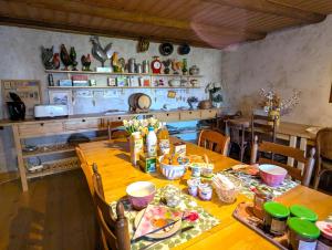 a dining room with a wooden table and chairs at Chambre Fleur bleue, les Volets Bleus in Laneuvelotte +7 photos