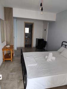 a bedroom with a large white bed and a table at Thea Monastiraki in Nafpaktos +14 photos