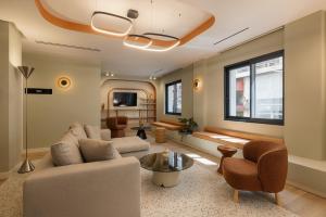 a living room with a couch and chairs at Leon by Zoia Living in Piraeus