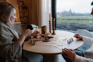 two women sitting at a table playing a board game at Polderlodge de Verademing in Goudriaan +31 photos