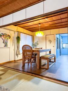a dining room with a table and a chair at PolePole in Takamatsu