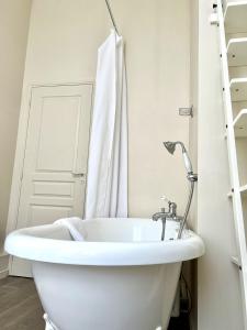 a white bathroom with a sink and a shower at Suite Luxe · Cour calme · Chartres centre in Chartres