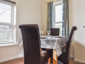a dining room with a table with two glasses on it at Farndale Apartment in Commondale