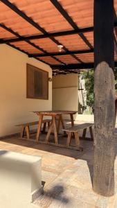 a wooden picnic table under a wooden roof at Pousada e Camping Carrion in Itu