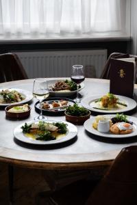 a table with plates of food and glasses of wine at The Royal Hotel in Bideford