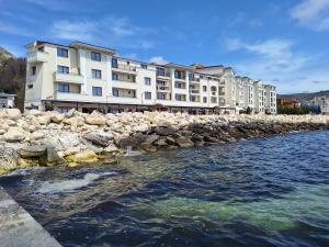 a row of buildings next to a body of water at Apartment Maraya 2, Carpe Diem complex, Balchik, free parking in Balchik