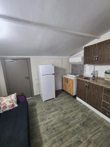 a small kitchen with a refrigerator and a counter at Şehzade Apart Otel in Fethiye