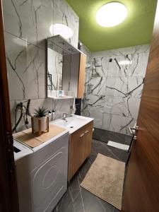 a bathroom with a sink and a toilet and a shower at Apartment Aby - Free Parking & Self Check-in in Slavonski Brod +33 photos