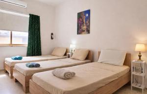 a room with three beds and a window at Seaview luxury flat 4 bedrooms in Sliema